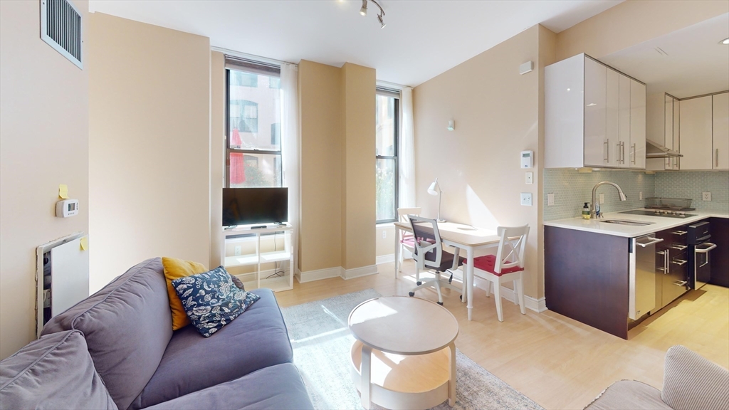 4 Charlesgate East, Unit 107 Boston, MA 02215 - Photo 8 of 23 a living room with furniture and a flat screen tv
