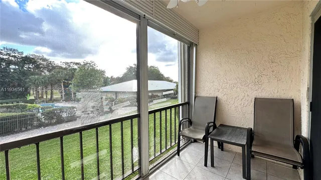 a view of a chair and table in the balcony