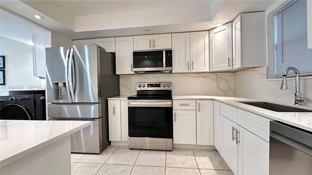 a kitchen with a sink stove and refrigerator