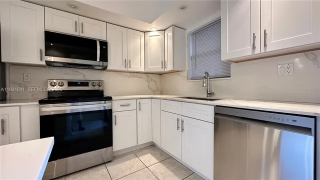 a kitchen with cabinets stainless steel appliances and cabinets