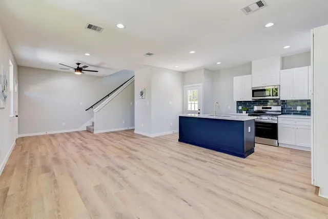 a view of kitchen with sink microwave and stove