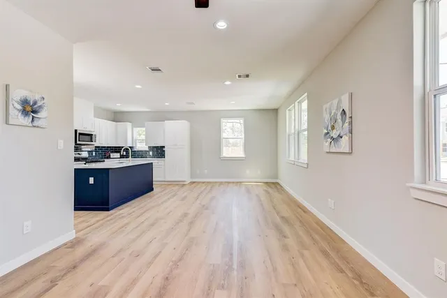 a view of kitchen with stove and cabinets