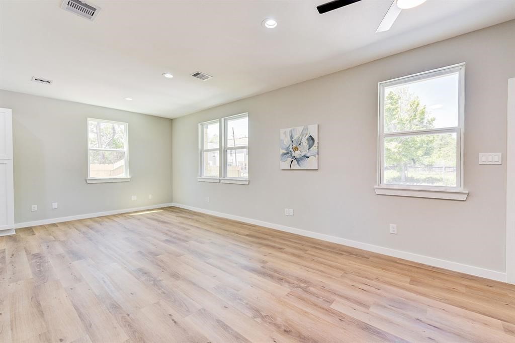 8404 Tate Street, Unit B Houston, TX 77028 - Photo 6 of 10 a view of an empty room with wooden floor and a window