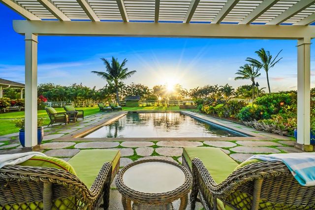 a view of swimming pool with a table and chairs