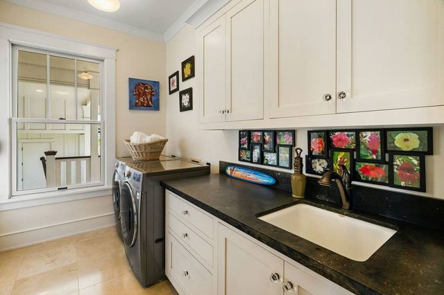 a kitchen with granite countertop a sink cabinets and window