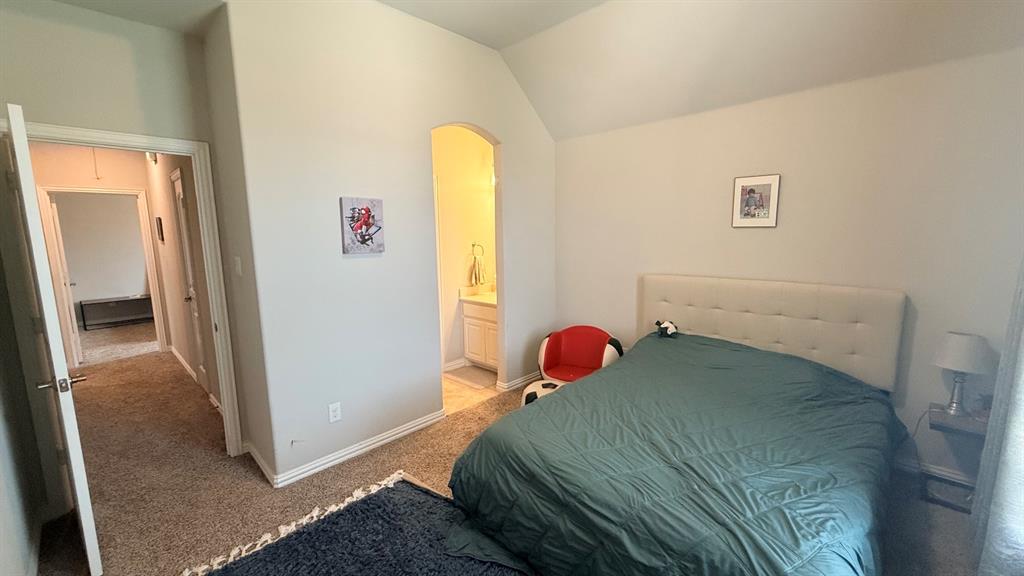337 Prairie Ridge Lane Lewisville, TX 75056 - Photo 19 of 28 a bedroom with a bed and a window
