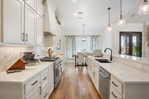 a kitchen with sink stove and cabinets