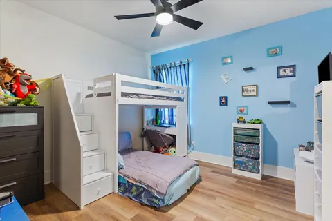 a bedroom with furniture and a baby crib