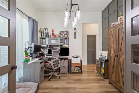 a view of a workspace with furniture and a window
