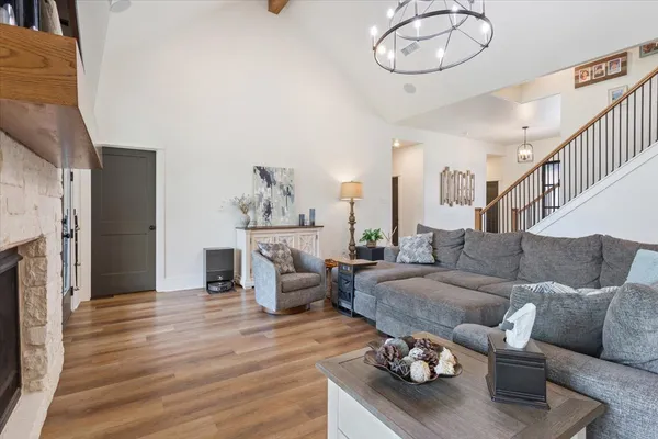 a living room with furniture kitchen view and a fireplace