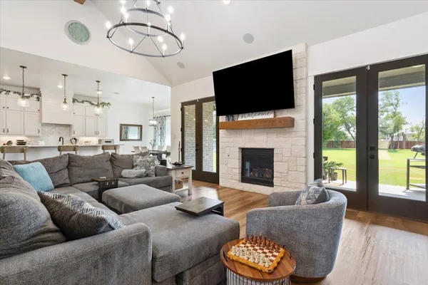 a living room with furniture a fireplace and a flat screen tv