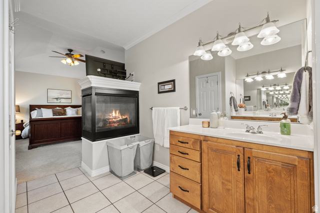 6208 West Bull River Road Highland, UT 84003 - Photo 35 of 90 Bathroom featuring a wood-finish vanity with a single sink, large mirror, and overhead light fixture