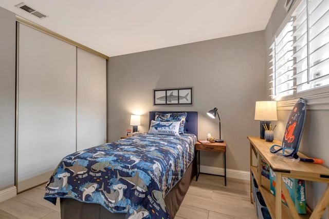 a bedroom with a bed and a flat screen tv