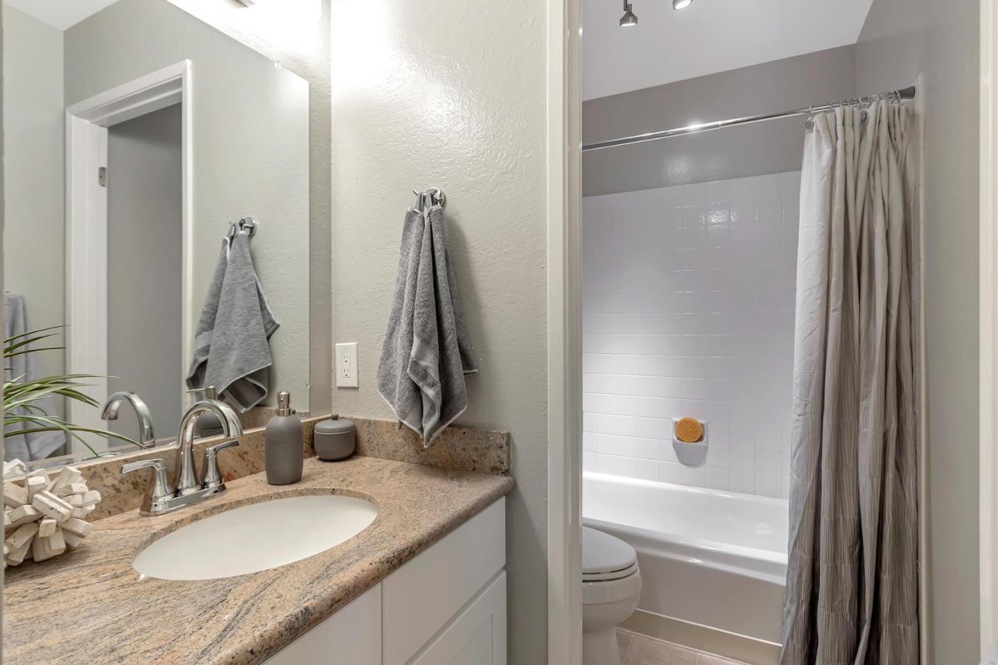 6609 Folklore Court San Jose, CA 95120 - Photo 14 of 21 a bathroom with a granite countertop sink and a mirror