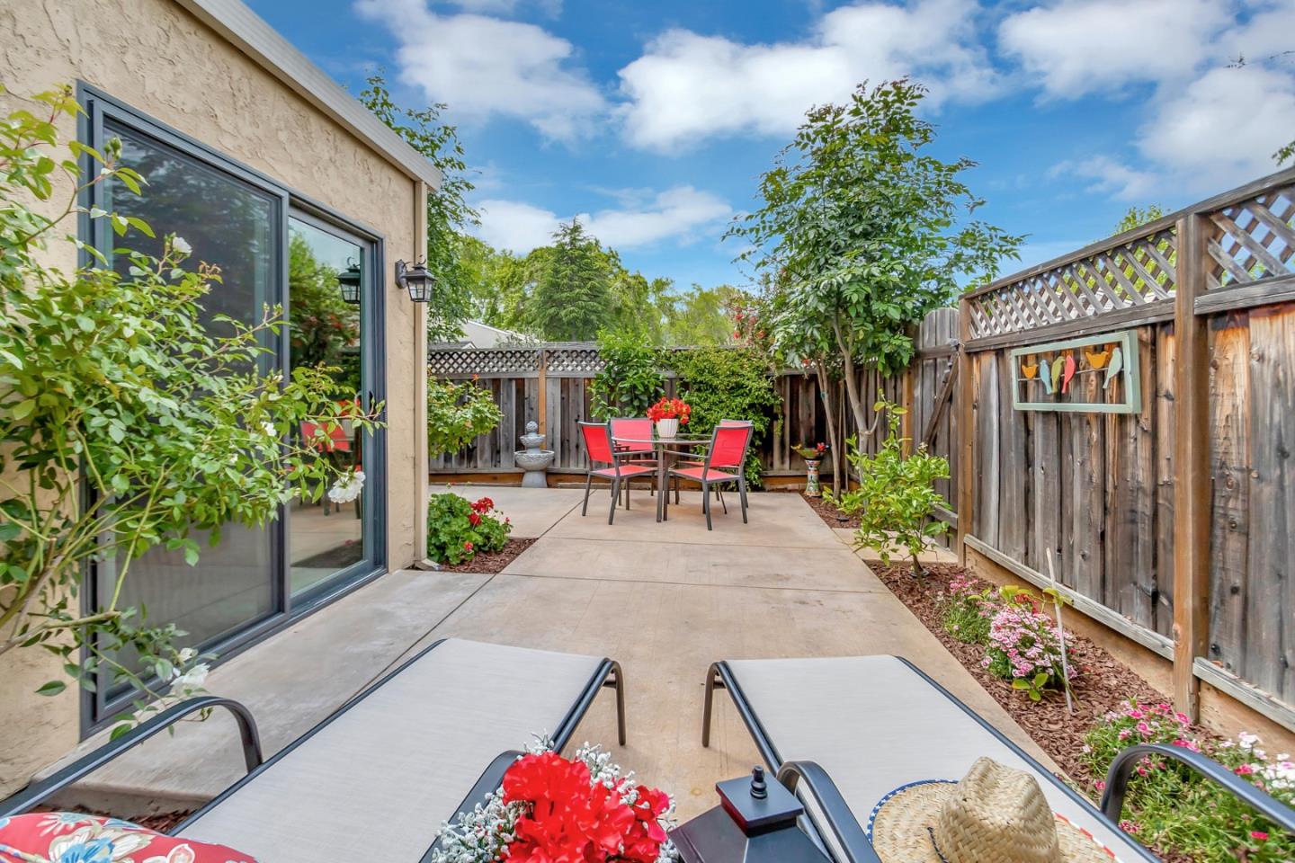 6609 Folklore Court San Jose, CA 95120 - Photo 16 of 21 a view of a patio with table and chairs potted plants with wooden floor and fence