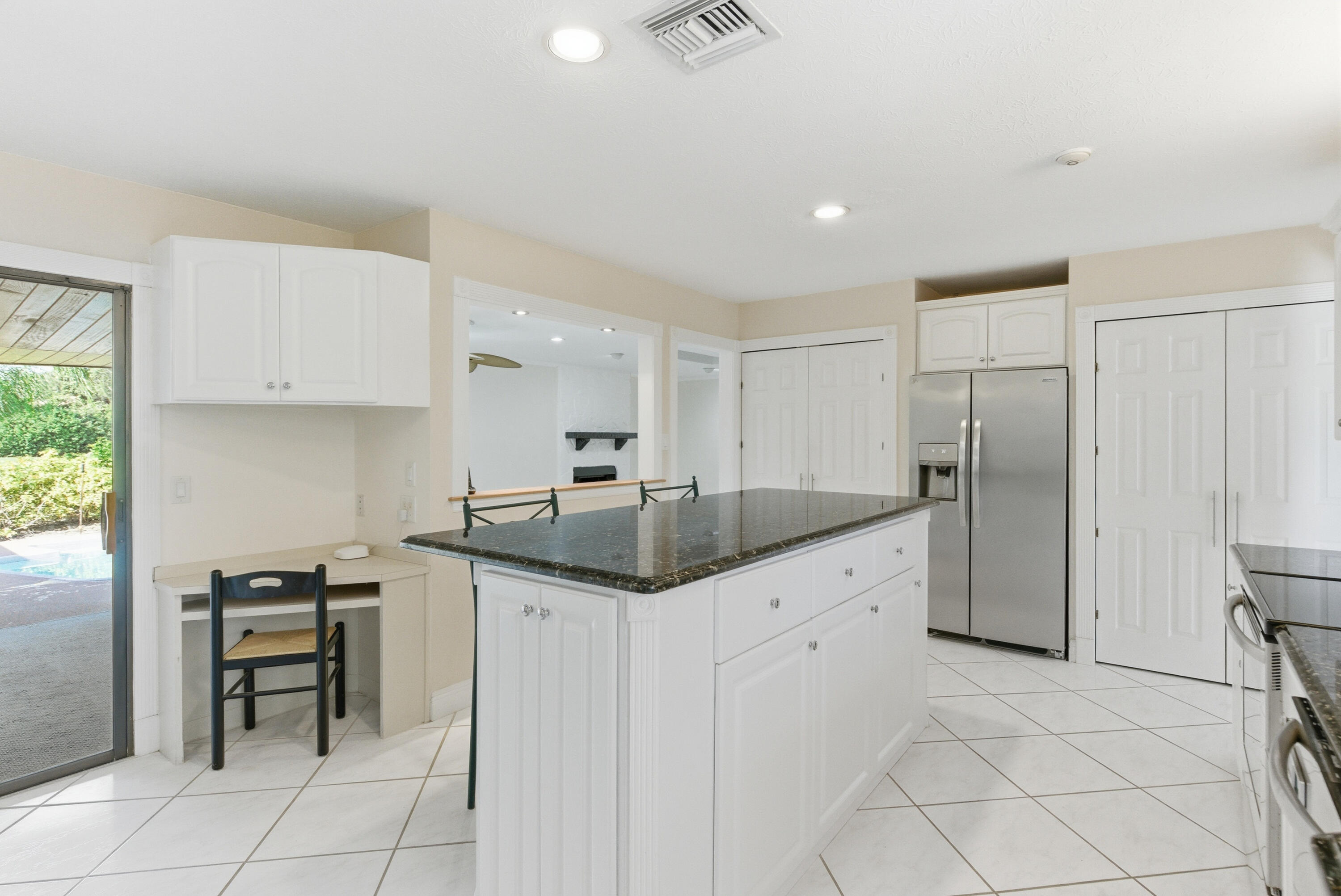 5151 Southeast Burning Tree Circle Stuart, FL 34997 - Photo 13 of 74 a kitchen with granite countertop a sink and cabinets