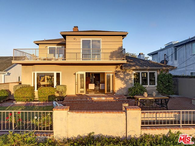 a front view of a house with swimming pool patio and outdoor seating