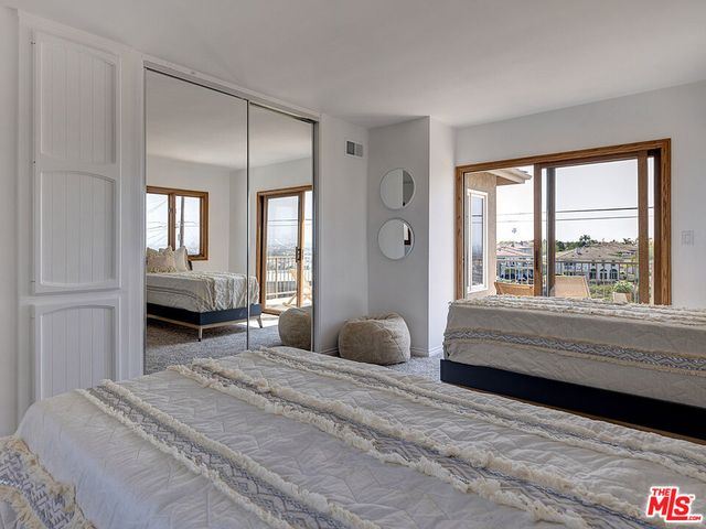 a bedroom with a bed and a large window