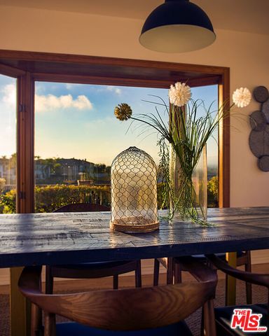 a view of a dining room with furniture and window