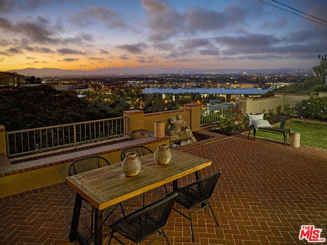 a terrace with outdoor seating and city view