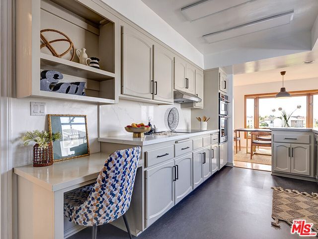 a kitchen with stainless steel appliances lots of counter top space cabinets and wooden floor