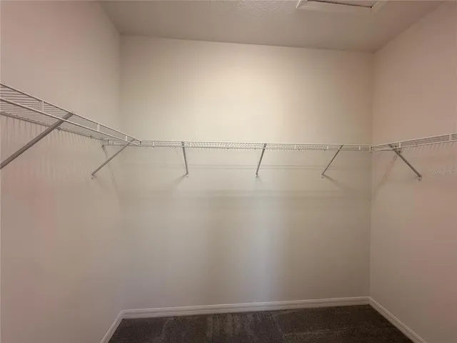 a spacious bathroom with a mirror sink and shower