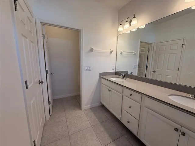 a bedroom with a bed and a rug