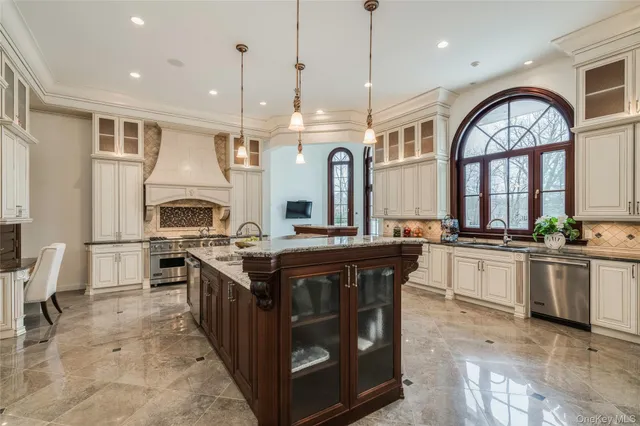 a kitchen with stainless steel appliances granite countertop a stove and a sink