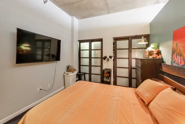 a bedroom with a bed and a flat screen tv