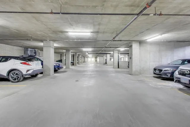 a view of parking garage with cars