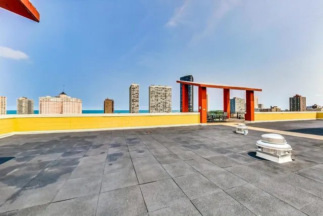 a view of swimming pool with outdoor seating and a yard