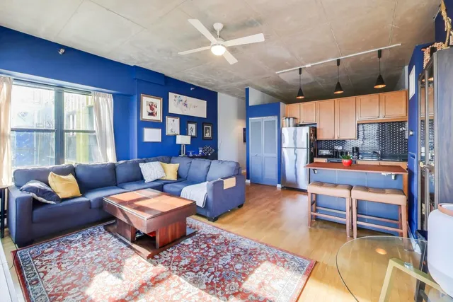 a living room with furniture a rug and a large window