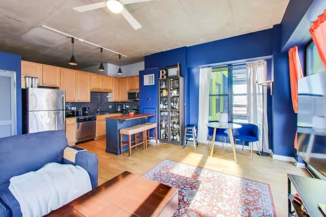 a living room with furniture and a dining table