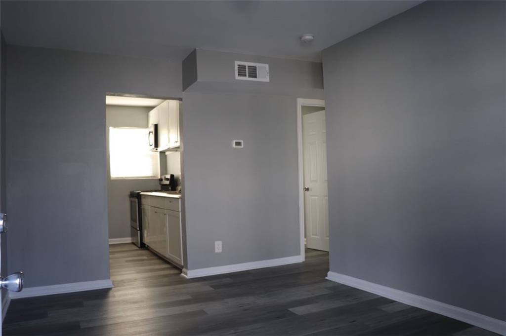 a view of a room with wooden floor sink and closet