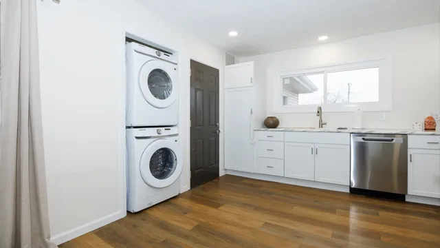 a kitchen with refrigerator cabinets and wooden floor