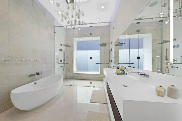 a large bathroom with a tub sink shower and mirror