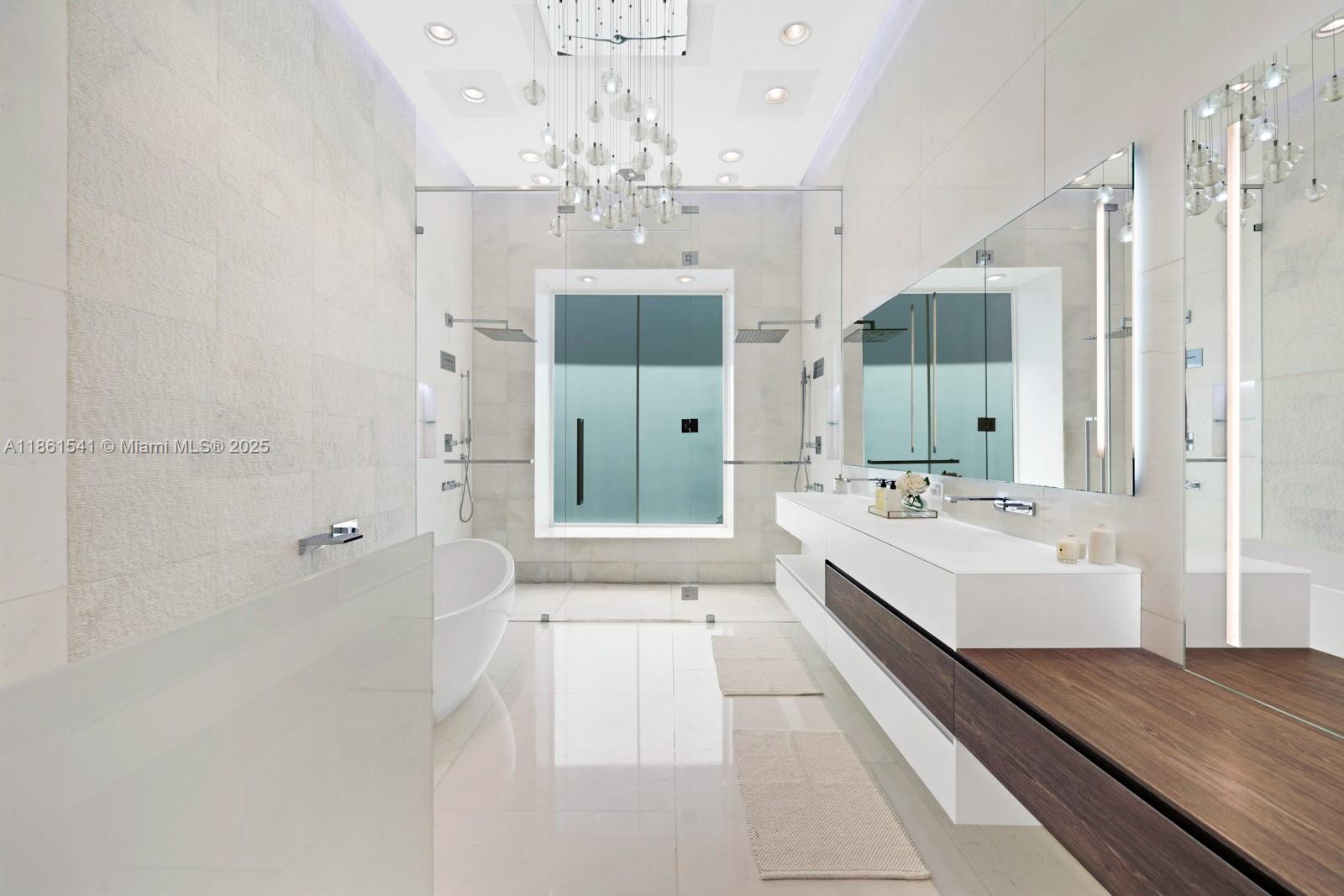 1825 Cleveland Road Miami Beach, FL 33141 - Photo 19 of 35 a large bathroom with a tub sink shower and mirror