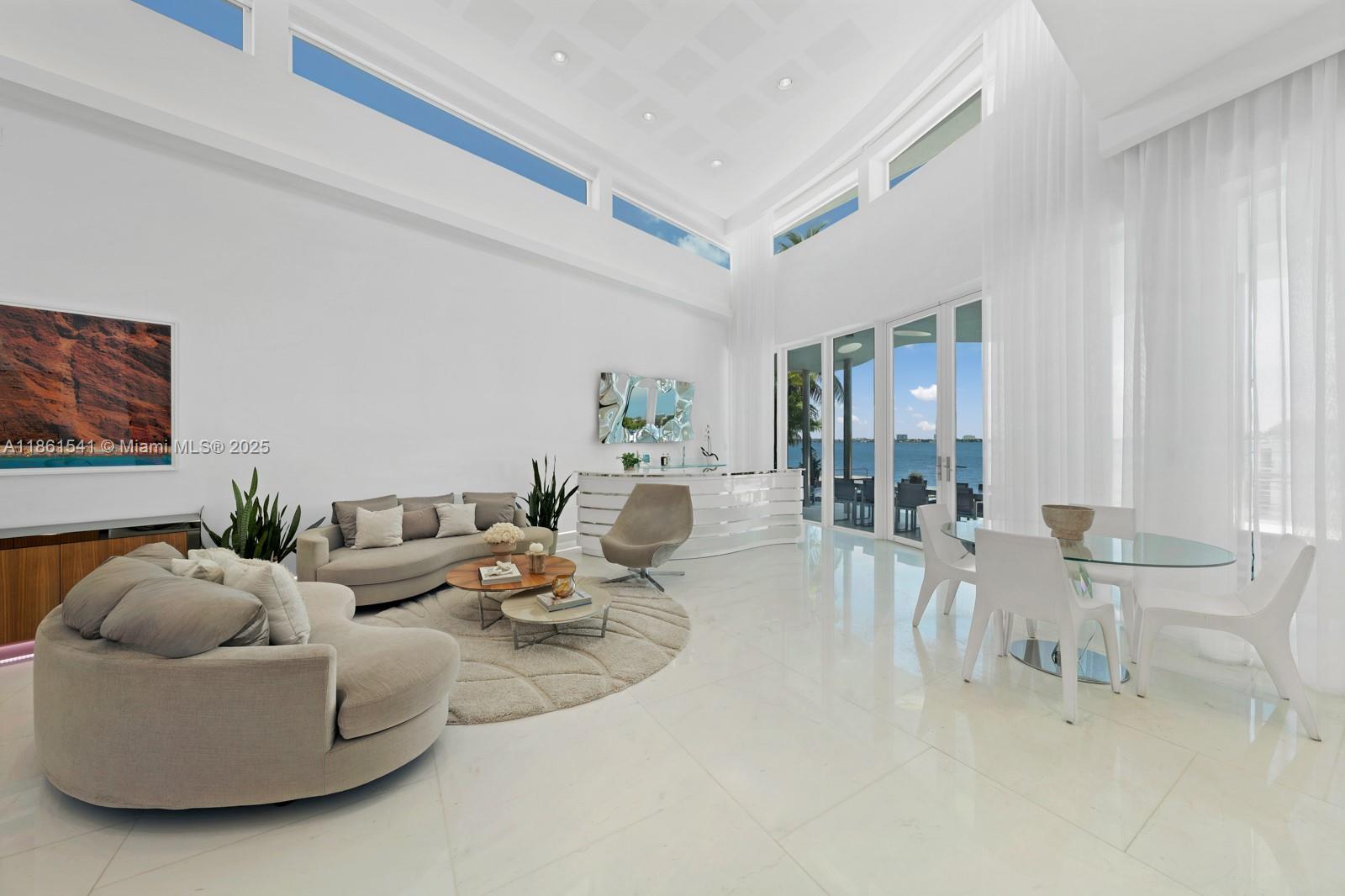 1825 Cleveland Road Miami Beach, FL 33141 - Photo 2 of 35 a living room with furniture and a large window