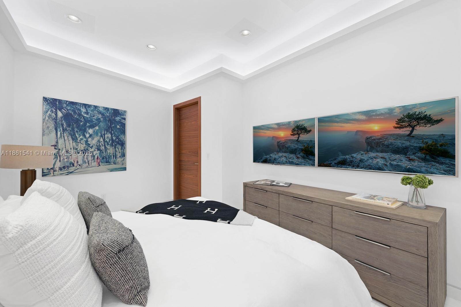 1825 Cleveland Road Miami Beach, FL 33141 - Photo 22 of 35 a bedroom with a large bed and a flat screen tv