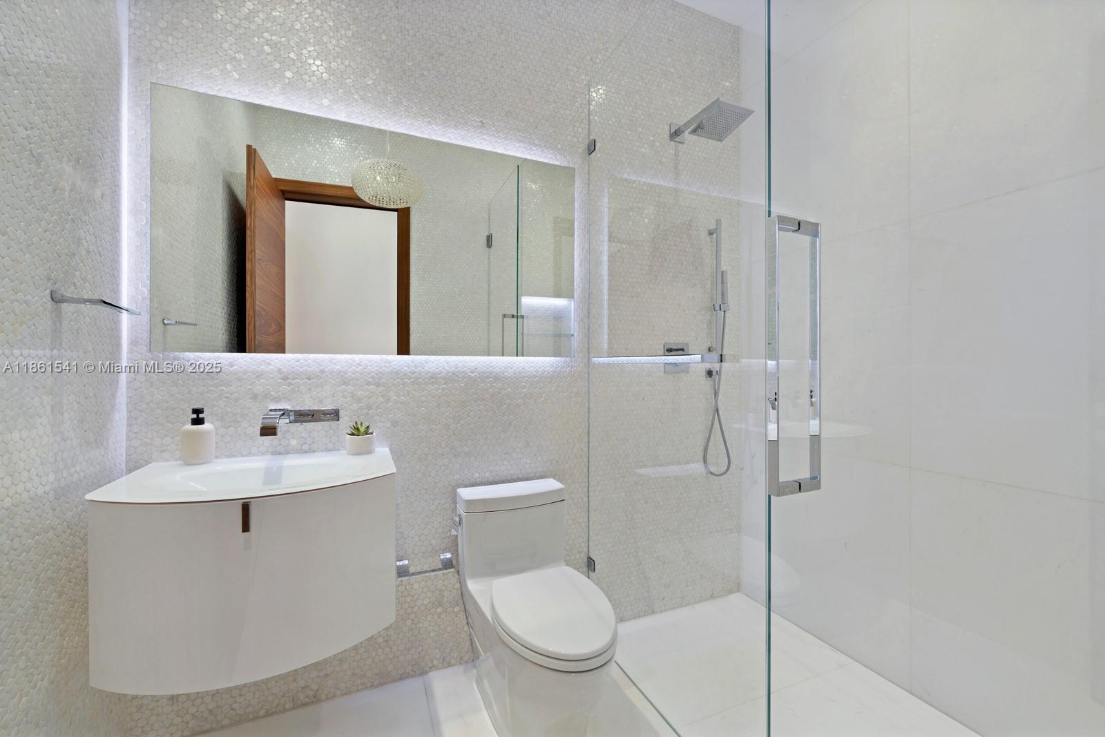 1825 Cleveland Road Miami Beach, FL 33141 - Photo 23 of 35 a bathroom with a toilet sink and shower
