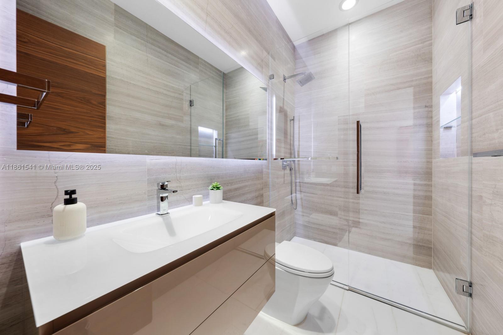 1825 Cleveland Road Miami Beach, FL 33141 - Photo 25 of 35 a bathroom with a sink a toilet and shower