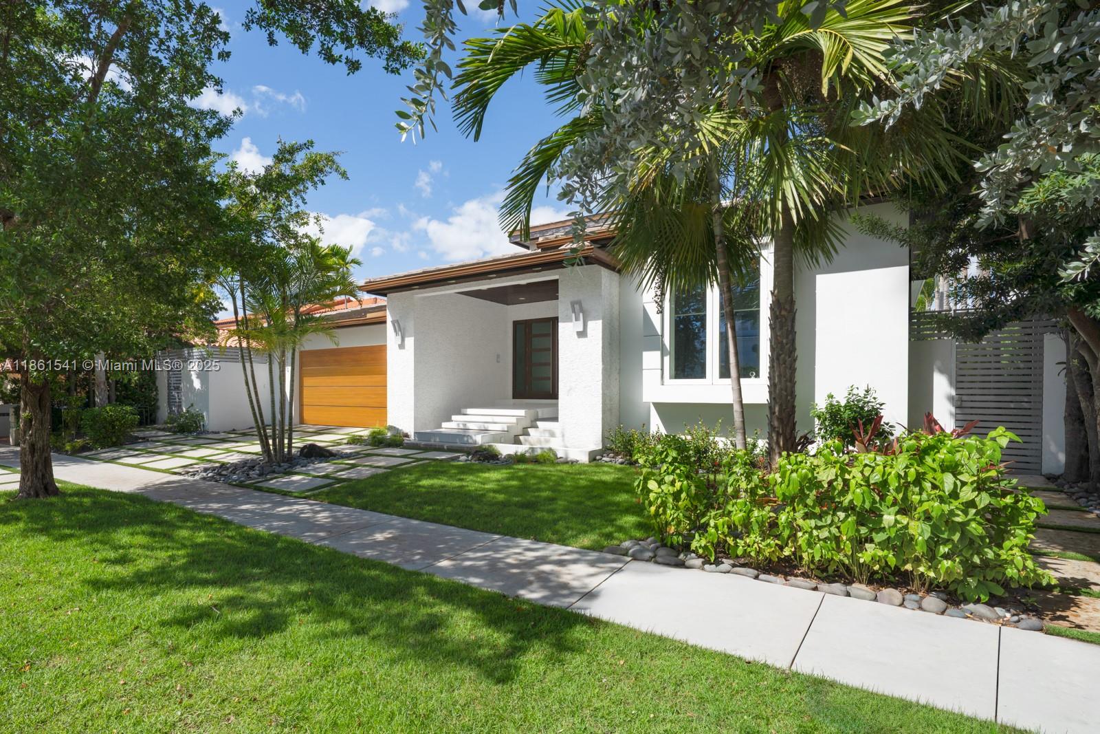1825 Cleveland Road Miami Beach, FL 33141 - Photo 29 of 35 a front view of a house with a yard and potted plants
