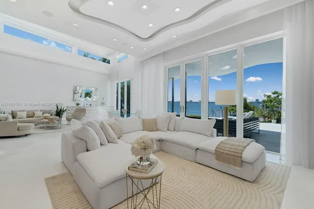 a living room with furniture and a large mirror