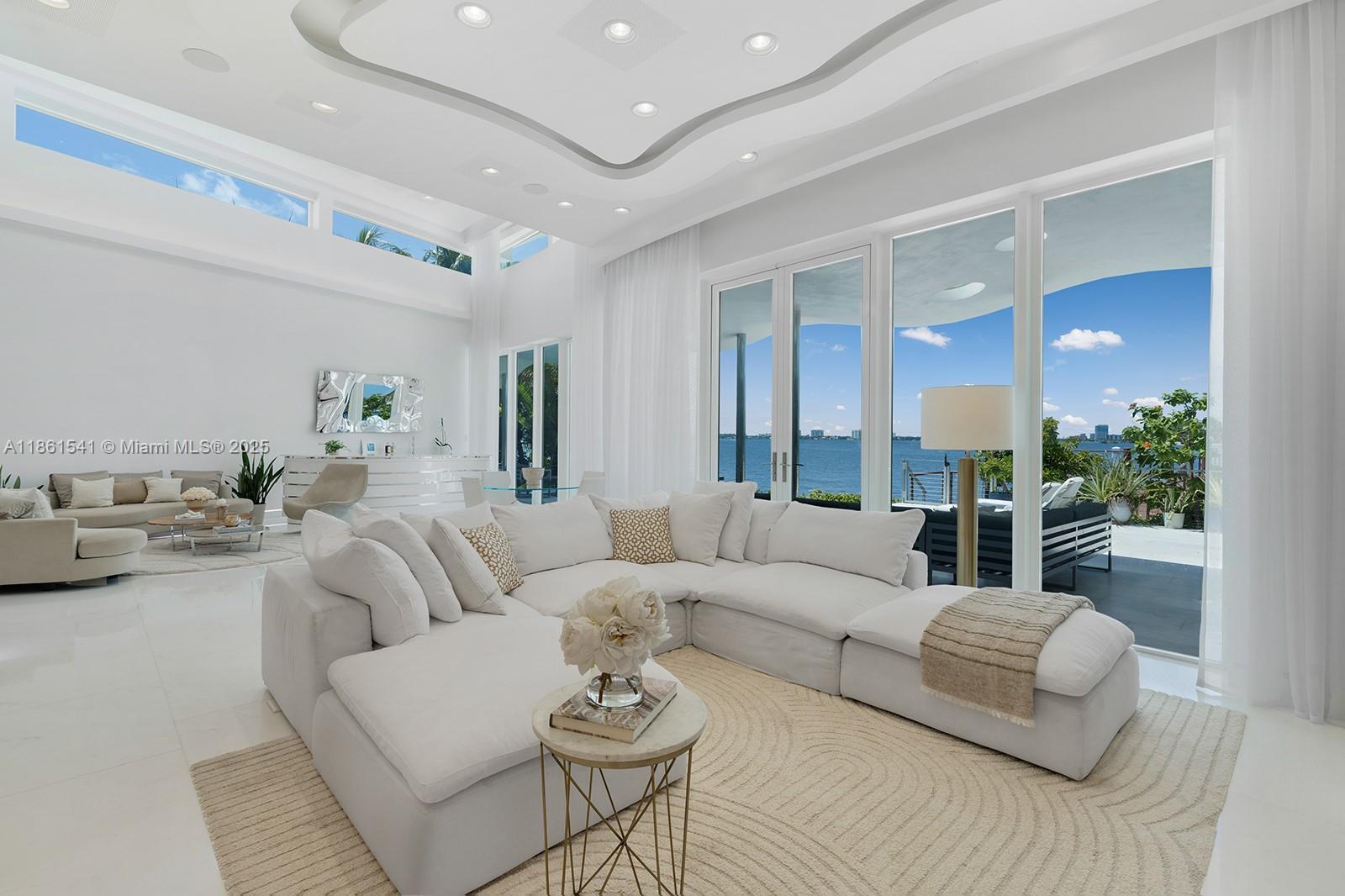 1825 Cleveland Road Miami Beach, FL 33141 - Photo 4 of 35 a living room with furniture and a large mirror