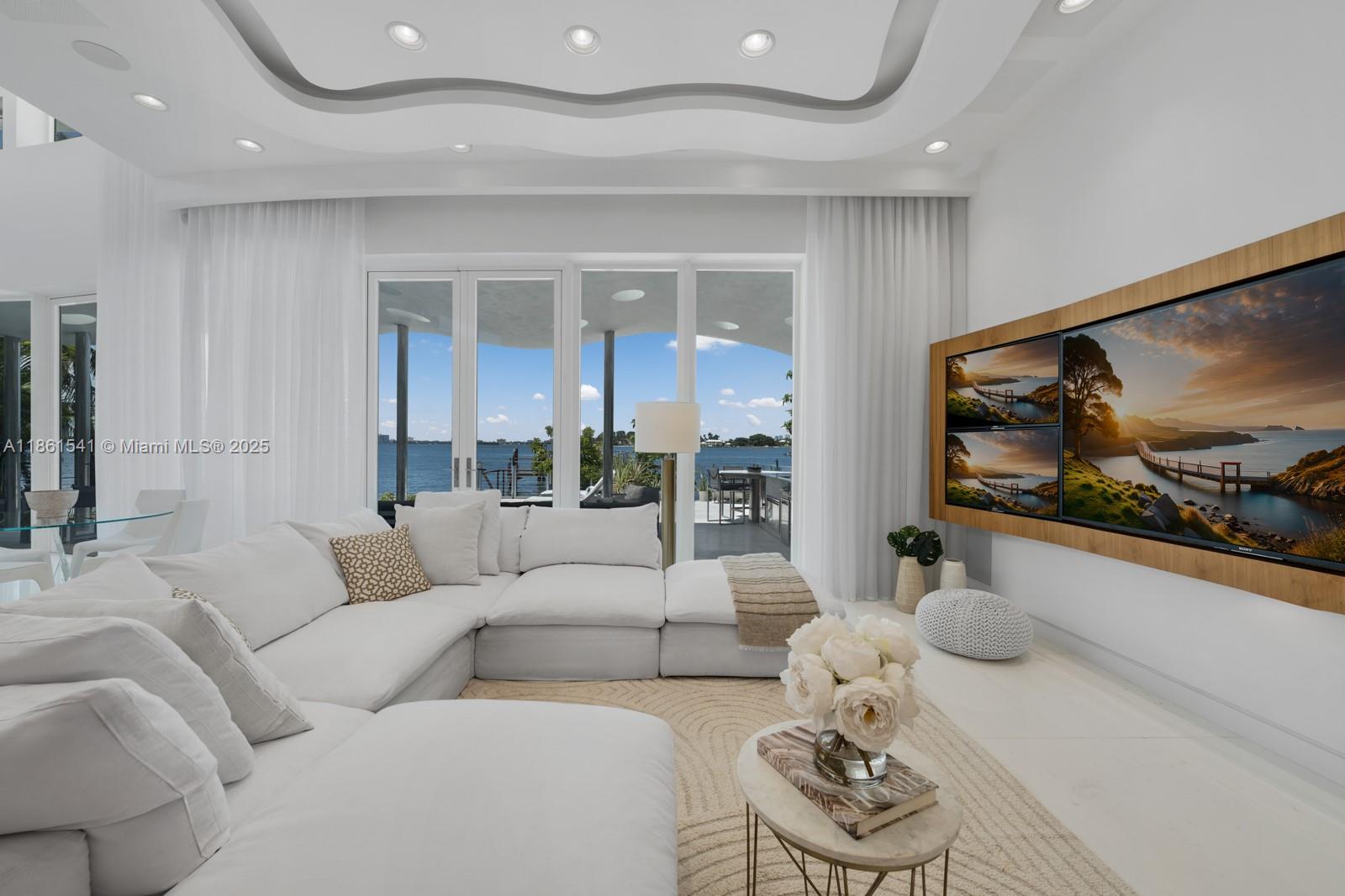 1825 Cleveland Road Miami Beach, FL 33141 - Photo 5 of 35 a living room with furniture and a large window