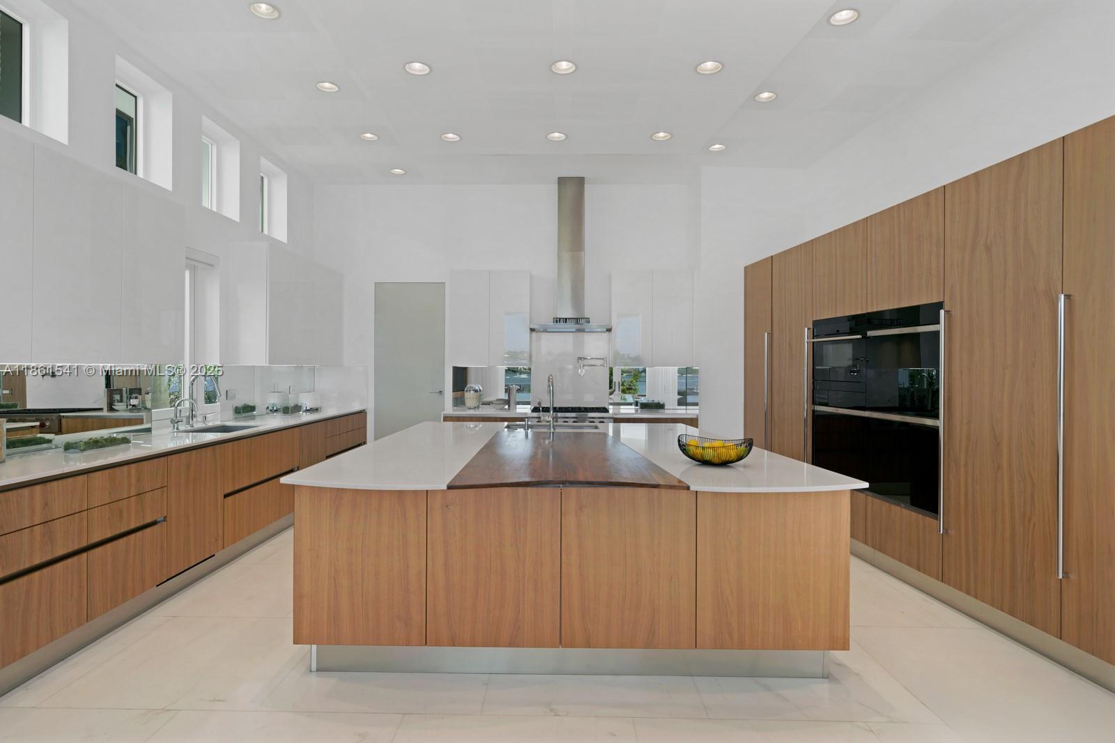 1825 Cleveland Road Miami Beach, FL 33141 - Photo 9 of 35 a kitchen with kitchen island granite countertop a sink and refrigerator