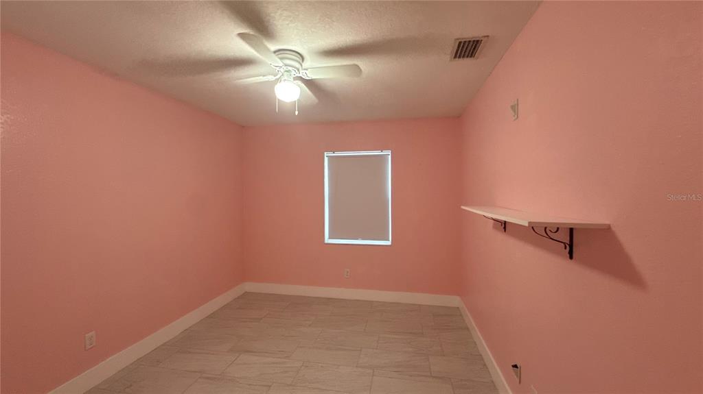 8106 Wichita Way Tampa, FL 33619 - Photo 19 of 21 an empty room with a fan & a window