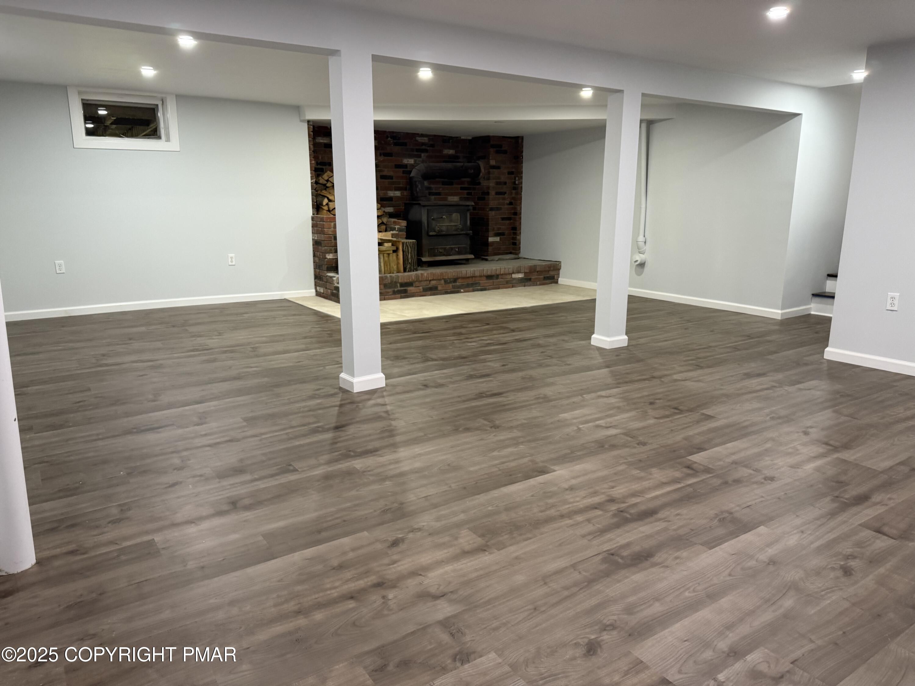 37 Seneca Road Mount Pocono, PA 18344 - Photo 38 of 46 an empty room with wooden floor and way to kitchen