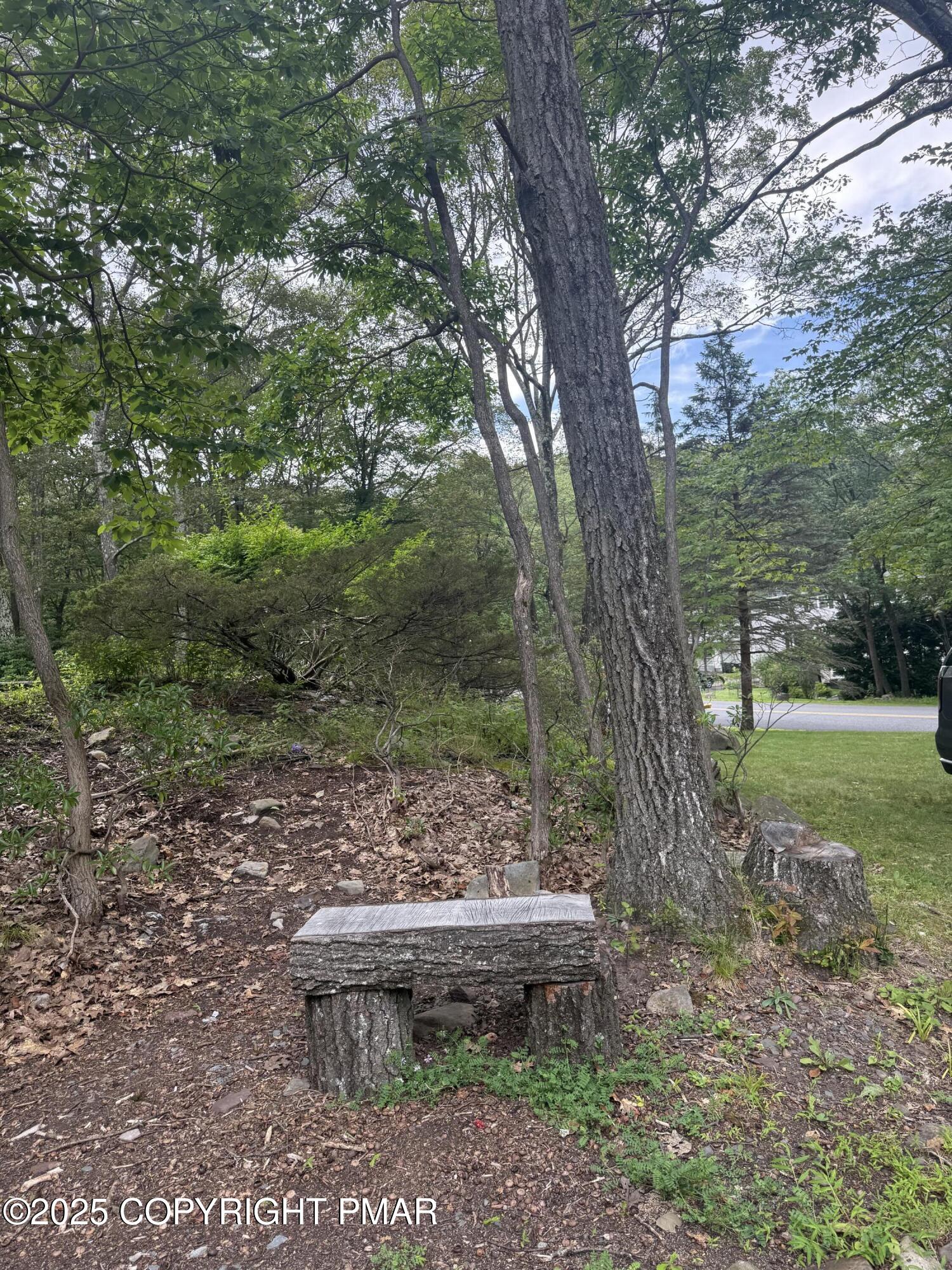 37 Seneca Road Mount Pocono, PA 18344 - Photo 42 of 46 a wooden bench sitting in the middle of a forest