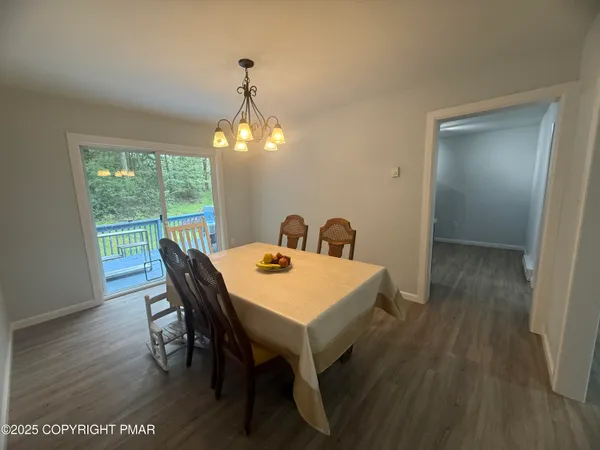 a view of a dining room with furniture and window